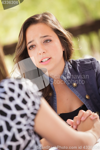 Image of Concerned Young Adult Woman Talking With Her Friend