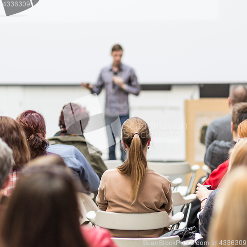 Image of Public speaker giving talk at Business Event.