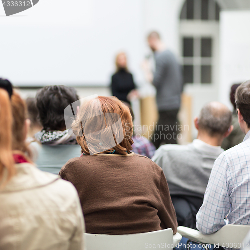 Image of Woman giving presentation on business conference.