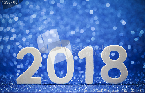 Image of New year 2018 white wood number on blue paper 