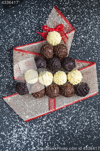 Image of Chocolate pralines shape Christmas tree on black