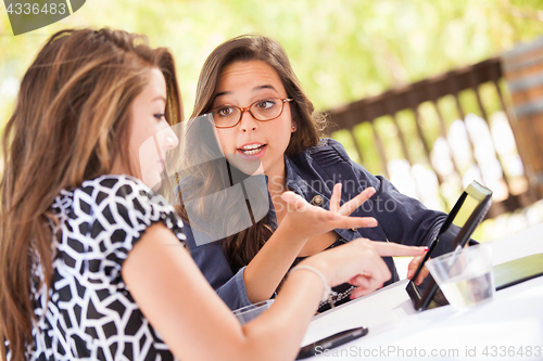 Image of Expressive Young Adult Girlfriends Using Their Computer Electron