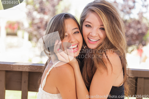 Image of Two Mixed Race Girlfriends Pose for Portrait Outdoors
