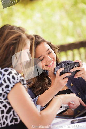 Image of Expressive Young Adult Girlfriends Using Their Computer Electron