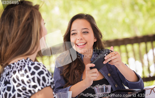 Image of Expressive Young Adult Girlfriends Using Their Computer Electron