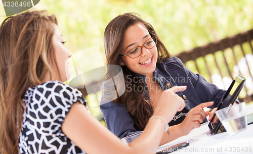 Image of Expressive Young Adult Girlfriends Using Their Computer Electron