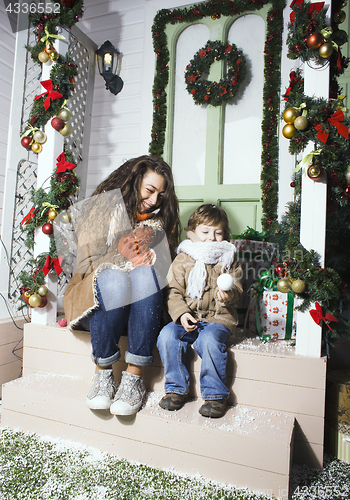 Image of happy smiling family on Christmas at house with gifts, young mot