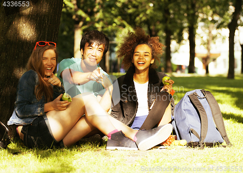 Image of cute group of teenages at the building of university with books 