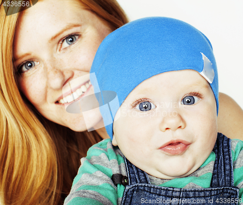 Image of young beauty mother with cute baby, red head happy modern family