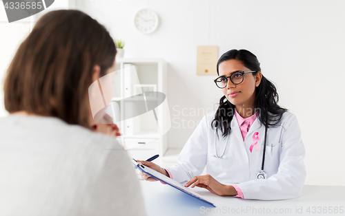 Image of doctor with pink awareness ribbon and patient