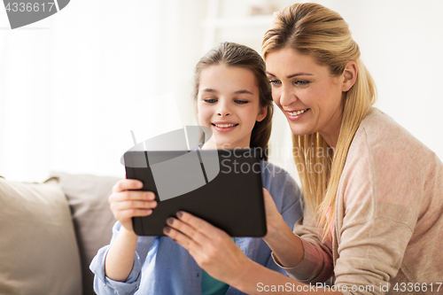 Image of happy family with tablet pc at home