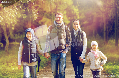 Image of happy family with backpacks hiking