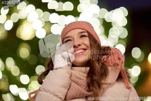 Image of happy woman calling on smartphone at christmas