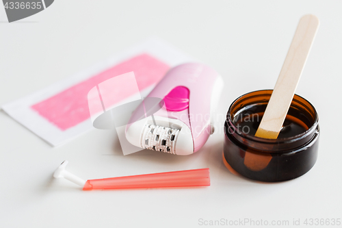 Image of safety razor, epilator, hair removal wax and patch