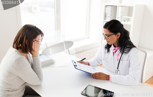 Image of doctor with pink awareness ribbon and patient