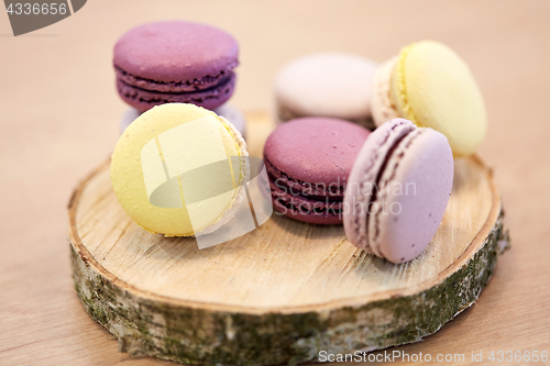 Image of different macarons on wooden stand