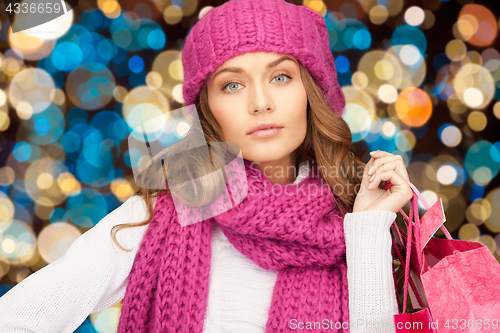 Image of woman in winter hat with christmas shopping bags