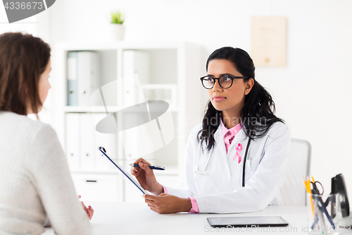 Image of doctor with pink awareness ribbon and patient