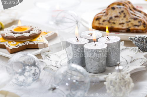 Image of Decorated Christmas table with gingerbread candle