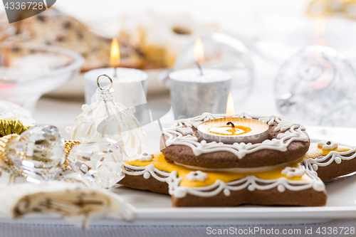 Image of Decorated Christmas table with gingerbread candle