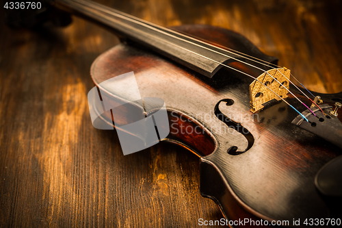 Image of Violin in vintage style on wood background