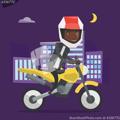 Image of African-american man riding motorcycle at night.