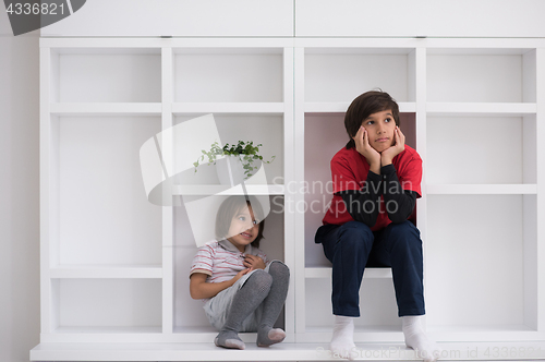 Image of young boys posing on a shelf
