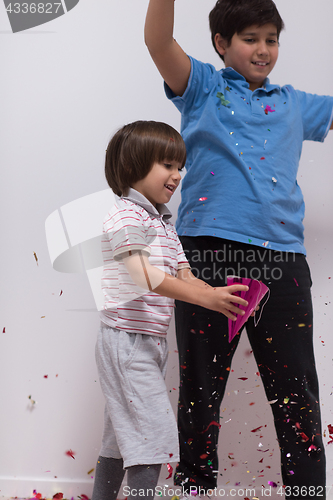 Image of kids  blowing confetti