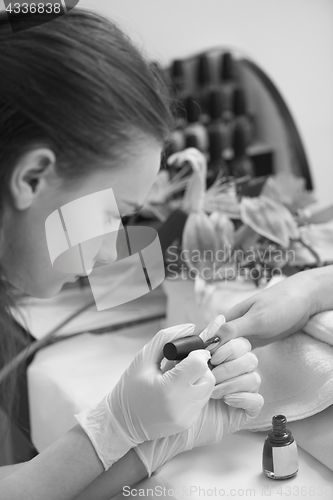 Image of Woman hands receiving a manicure