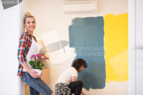 Image of happy young couple doing home renovations