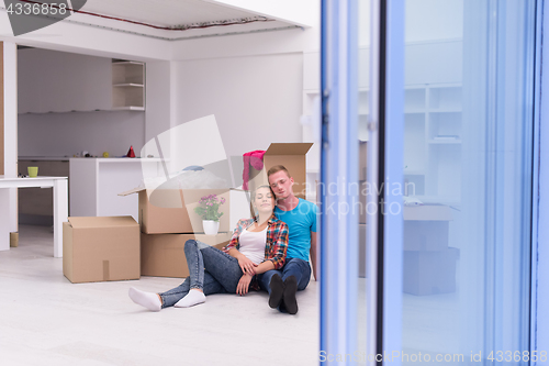 Image of young couple moving  in new house