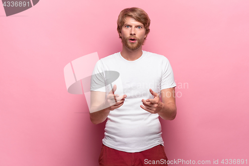 Image of Portrait of young man with shocked facial expression