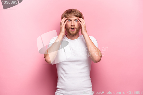 Image of Portrait of young man with shocked facial expression