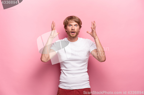 Image of Portrait of young man with shocked facial expression