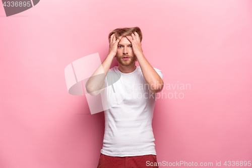 Image of Portrait of young man with shocked facial expression