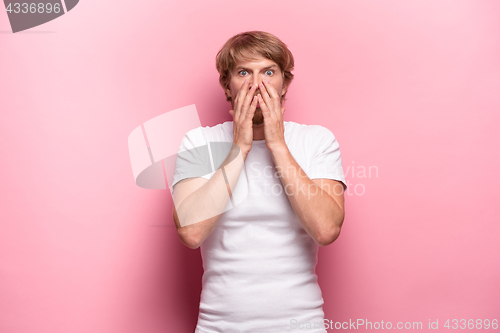 Image of Portrait of young man with shocked facial expression