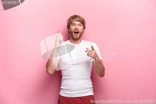 Image of Portrait of young man with shocked facial expression