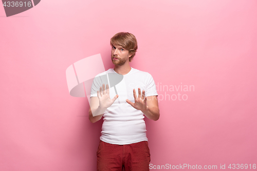 Image of Negative human facial expressions, emotions and feelings. Portrait of squeamish disgusted young man