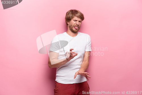 Image of Negative human facial expressions, emotions and feelings. Portrait of squeamish disgusted young man