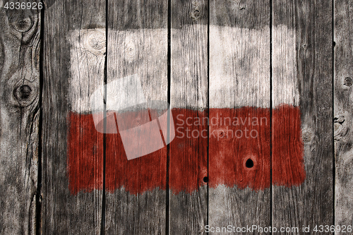 Image of flag of poland on aged wooden wound