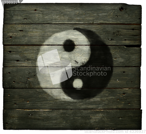 Image of yin yang symbol on old wooden planks