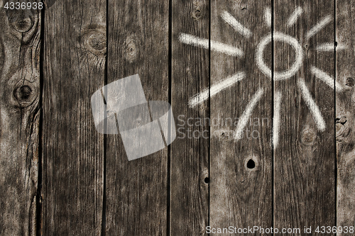 Image of sun symbol on wooden background