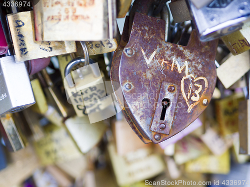 Image of Love locks in Paris bridge symbol of friendship and romance