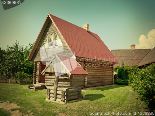 Image of wooden house and well in the yard