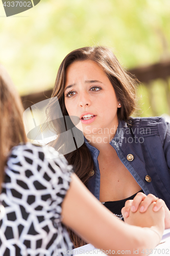 Image of Concerned Young Adult Woman Talking With Her Friend
