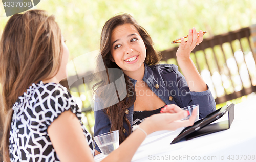 Image of Expressive Young Adult Girlfriends Using Their Computer Electron