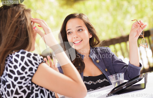 Image of Expressive Young Adult Girlfriends Using Their Computer Electron