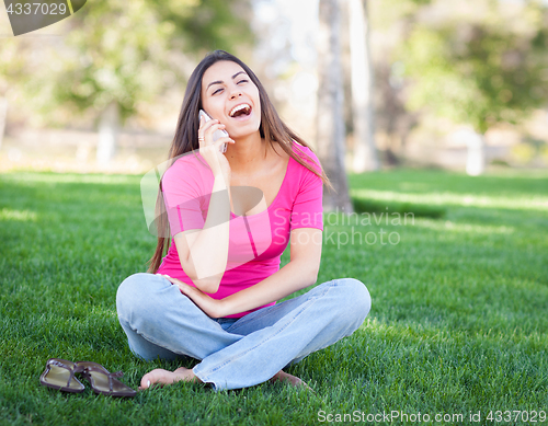 Image of Beautiful Young Ethnic Woman Talking on Her Smartphone Outside.