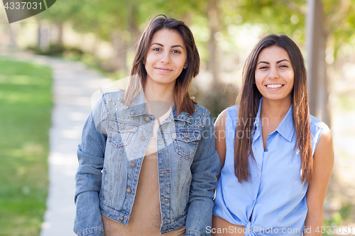 Image of Two Beautiful Ethnic Twin Sisters Portrait Outdoors.