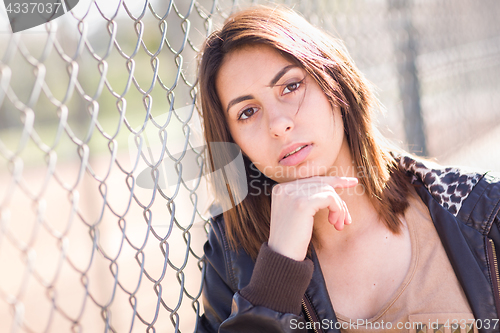 Image of Beautiful Meloncholy Mixed Race Young Woman Portrait Outside.